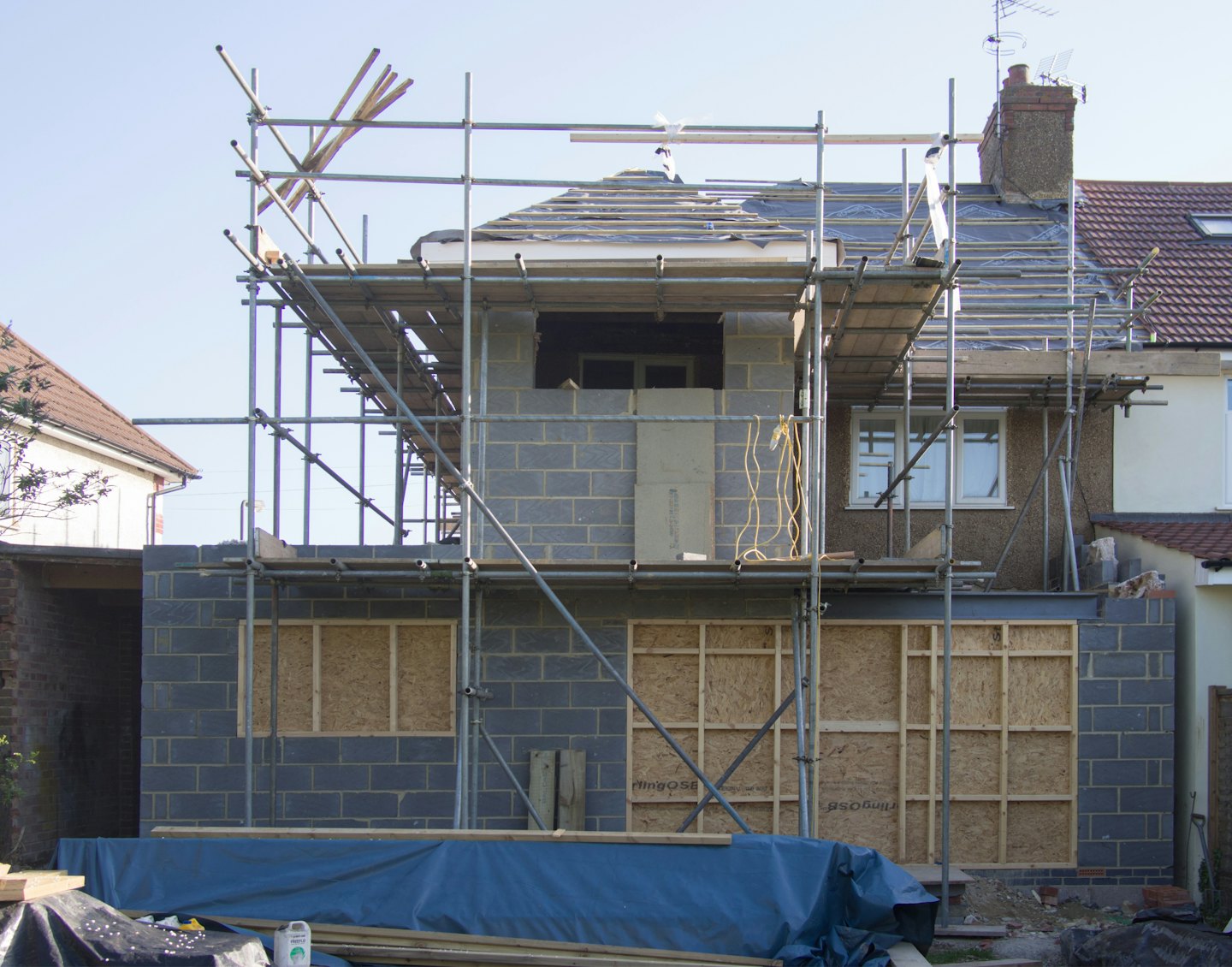 House extension with concrete block walls and scaffolding.